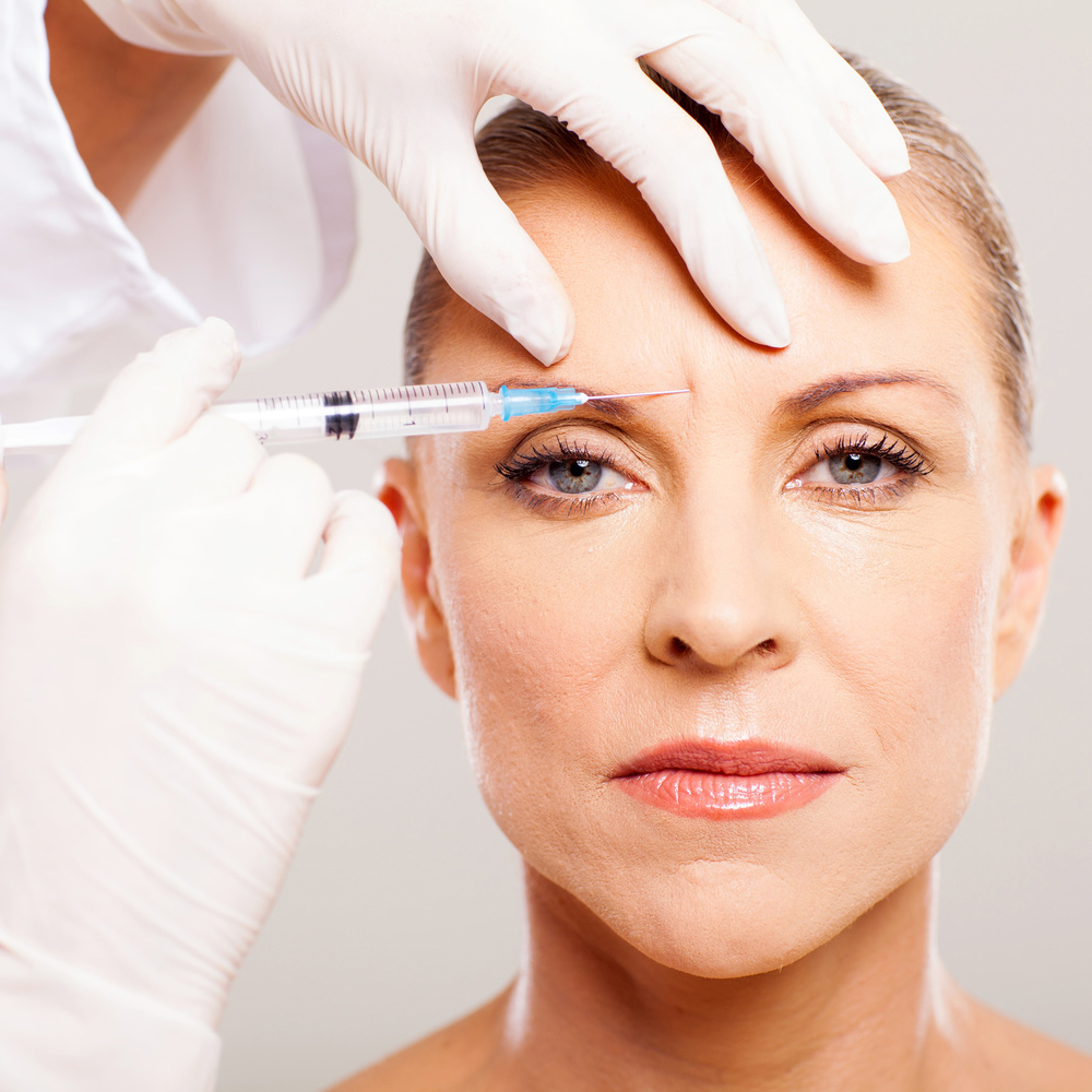 cosmetic surgeon giving face lifting injection